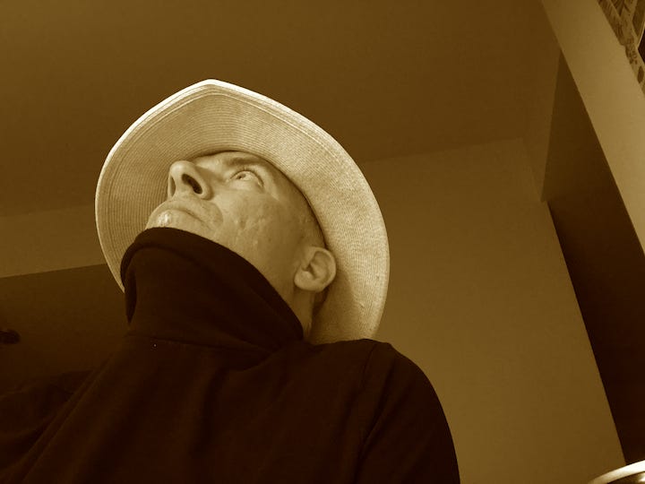 photo of author Faux Jean, with straw hat and sepia vibes.