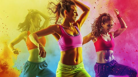 Smiling women in colorful workout clothes performing Zumba routines, capturing the fun and energy of the class.