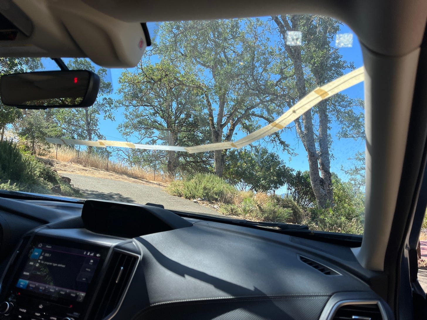 A taped crack in our car windshield