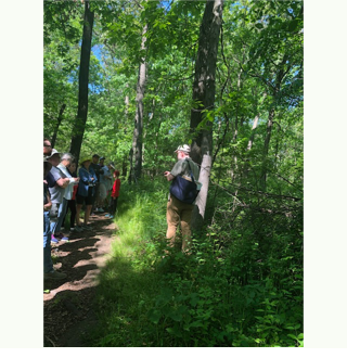 A group of people in the woods

Description automatically generated