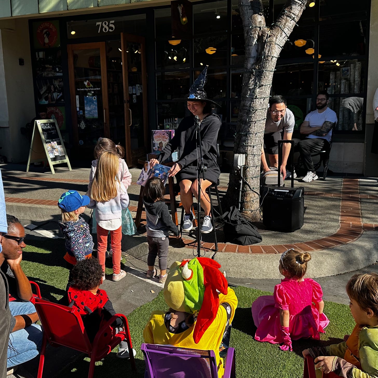 Kids lining up to interact with THE BOO CREW NEEDS YOU! as Vicky reads in front of The Reading Bug bookstore