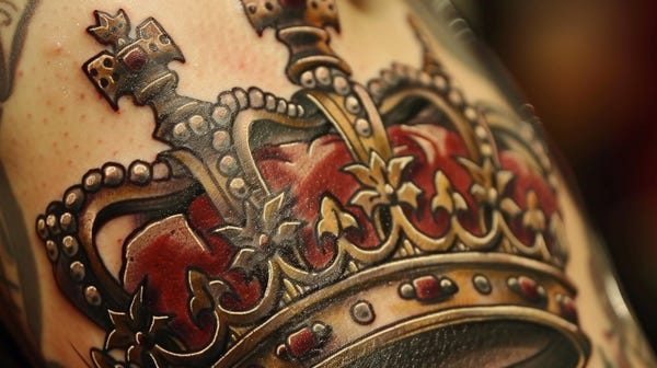Elaborate queen's crown tattoo adorned with pearls and gems, inked in realistic shades of red and gold on the upper arm.