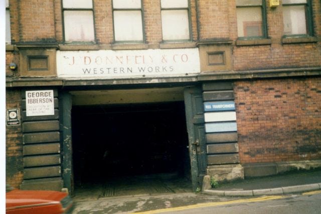 The outside entrance to Western Works in Sheffield from the Seventies with a square street entrance