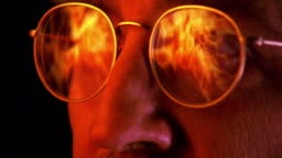 Close Up Zoom In To Extreme Close Up Reflection Of Fire In Eyeglasses Of  Man With Mustache - HD Stock-Video - Getty Images