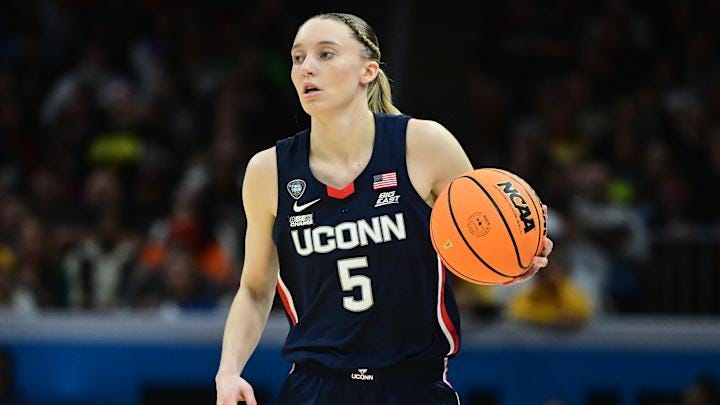 Apr 5, 2024; Cleveland, OH, USA; Connecticut Huskies guard Paige Bueckers (5) dribbles the ball against the Iowa Hawkeyes in the semifinals of the Final Four of the womens 2024 NCAA Tournament at Rocket Mortgage FieldHouse. Mandatory Credit: Ken Blaze-Imagn Images