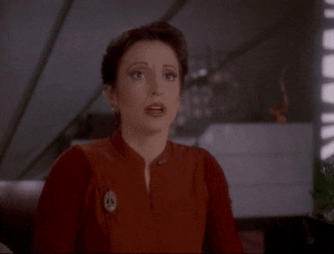 Kira on Deep Space Nine looking back and forth in confusion