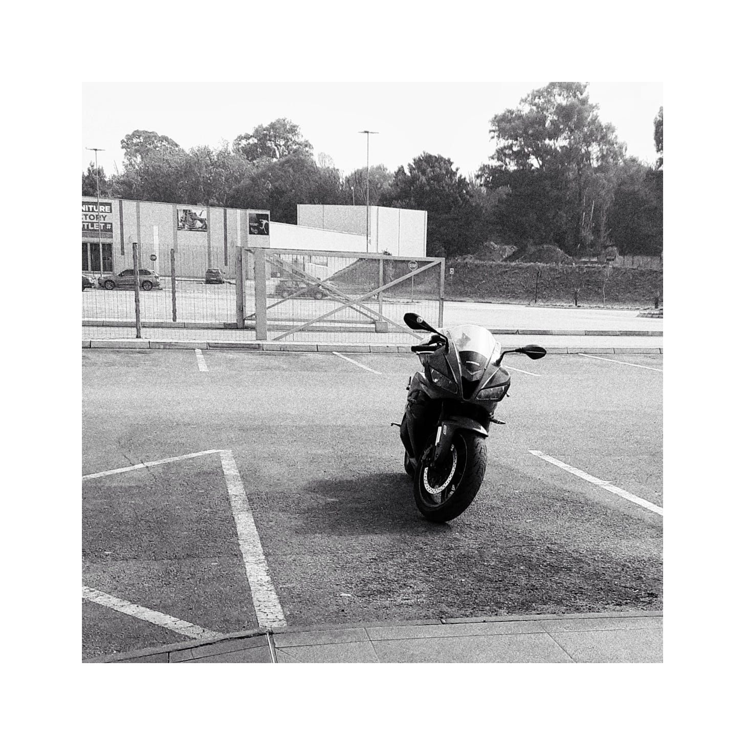 A motorcycle standing in a parking lot