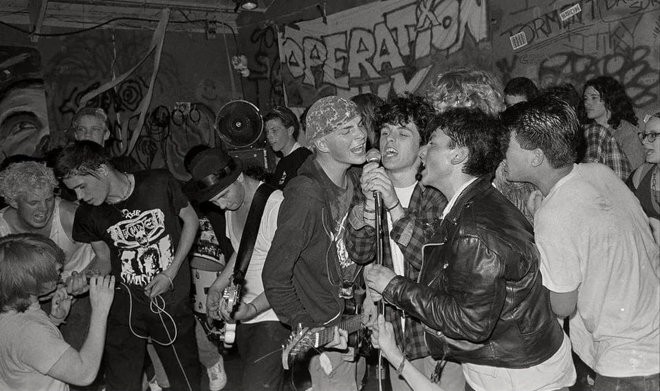 r/punk - Billie Joe Armstrong singing on stage with Operation Ivy at 924 Gilman St., circa 1988