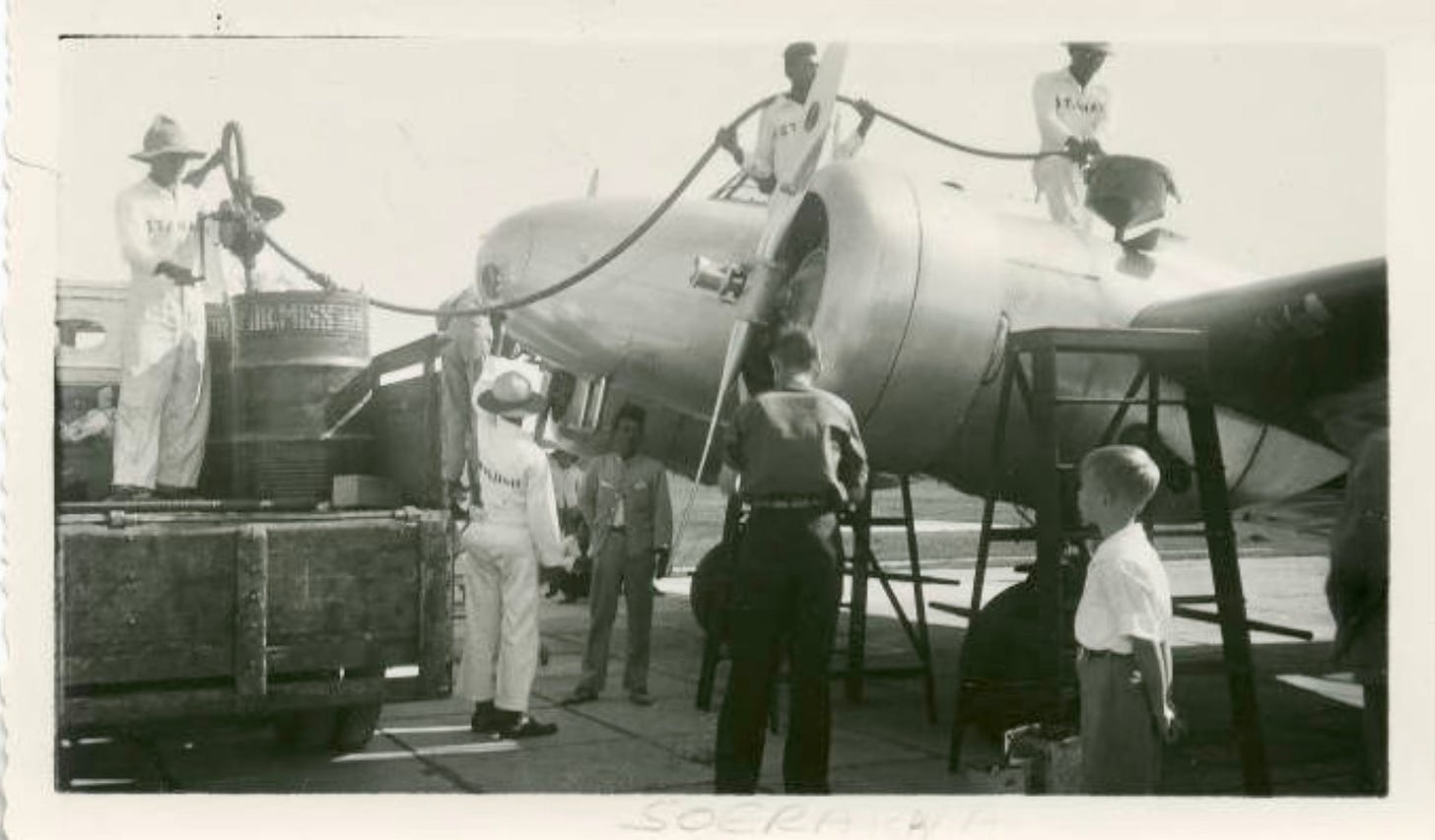 Ground crew refueling Amelia Earhart’s plane in Surabaya with Fred Noonan, her flight navigator