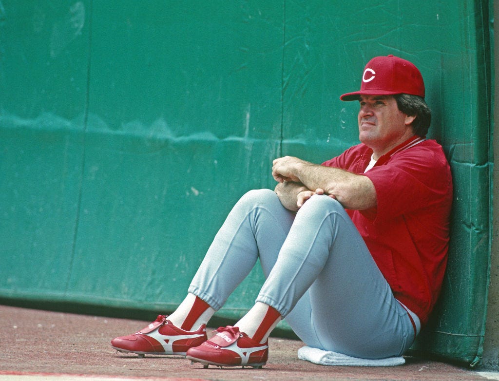 Pete Rose, up against the dugout, during a game between the Cincinnati Reds and Pittsburgh Pirates in 1987 (Photo: George Gojkovich/Getty Images).