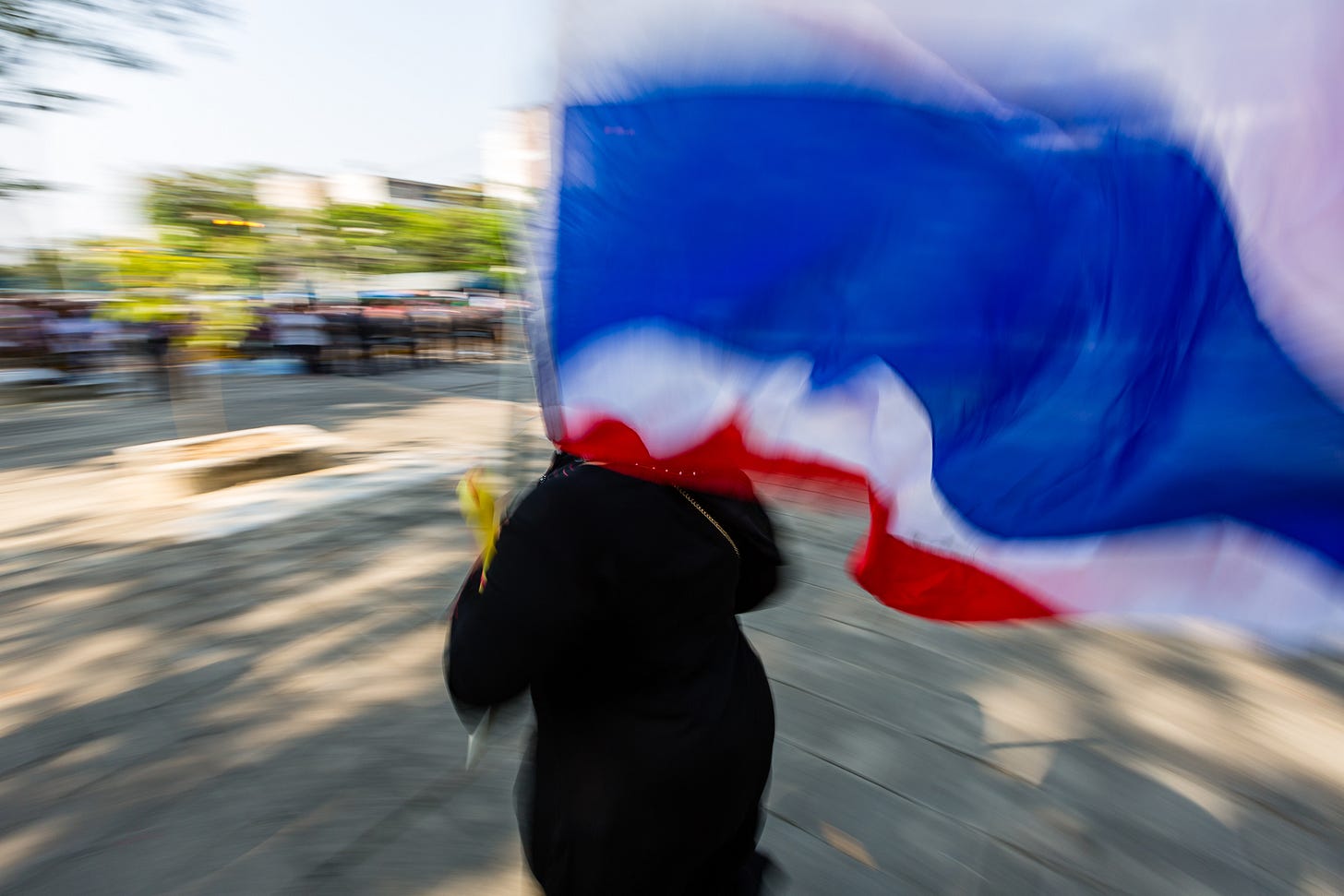Protestor and Thai flag running from gunfire. 1/30, f/11, ISO 100, 16mm