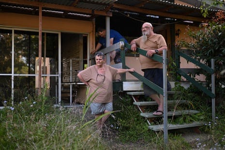Allan and Lynette Kunst, with their son Douglas Gooding (at rear), former residents of Enid Street in Goodna are photographed in their condemned home