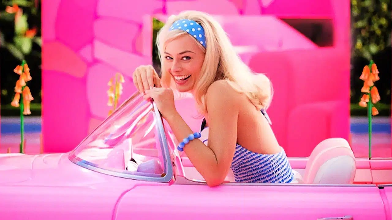 Margot Robbie in her role as Barbie, driving a convertable