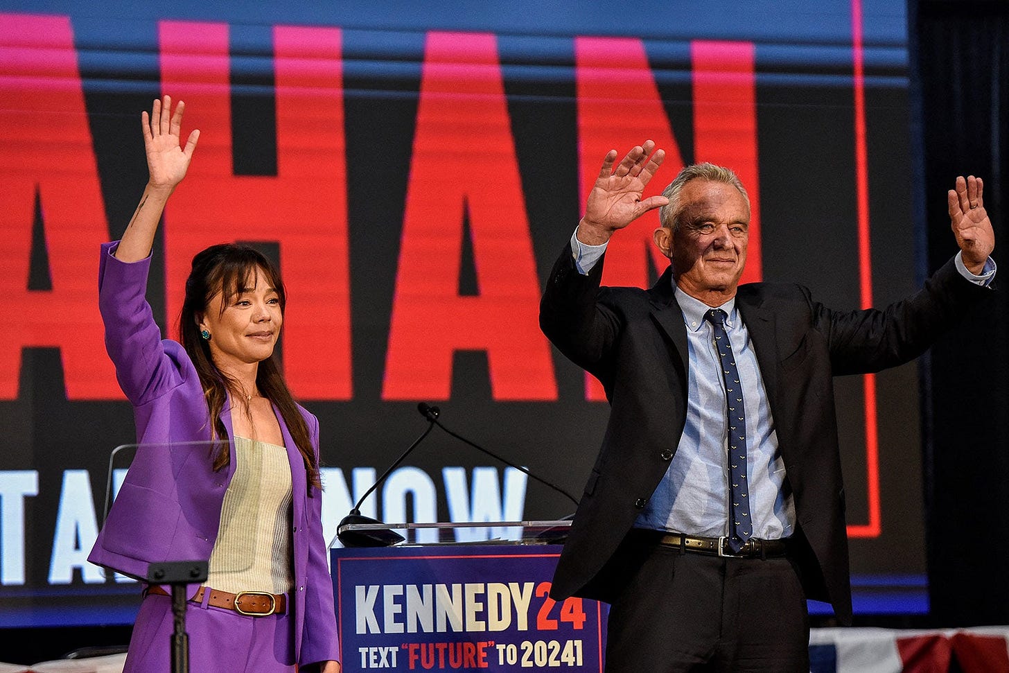 Shanahan and Kennedy wave onstage, side by side.