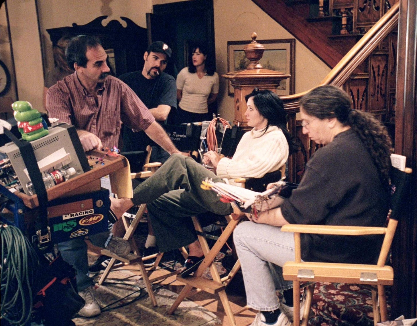 Several people behind the scenes on the set of Charmed, including Shannen Doherty