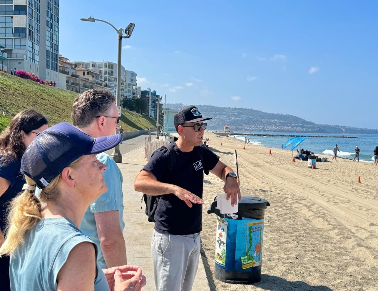 May be an image of 6 people, beach and text