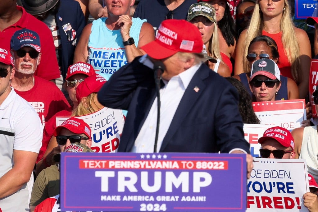 Trump reacts as multiple shots rang out during a campaign rally at the Butler Farm Show in Butler, Pennsylvania, U.S., July 13, 2024. 