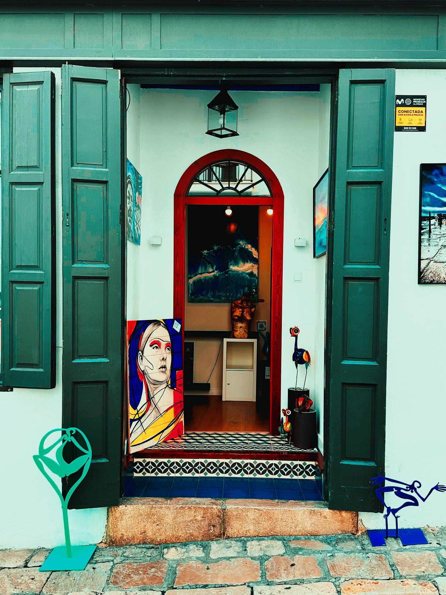 An Invitation to Creativity - A vibrant gallery doorway in Sitges, where art beckons from every corner.