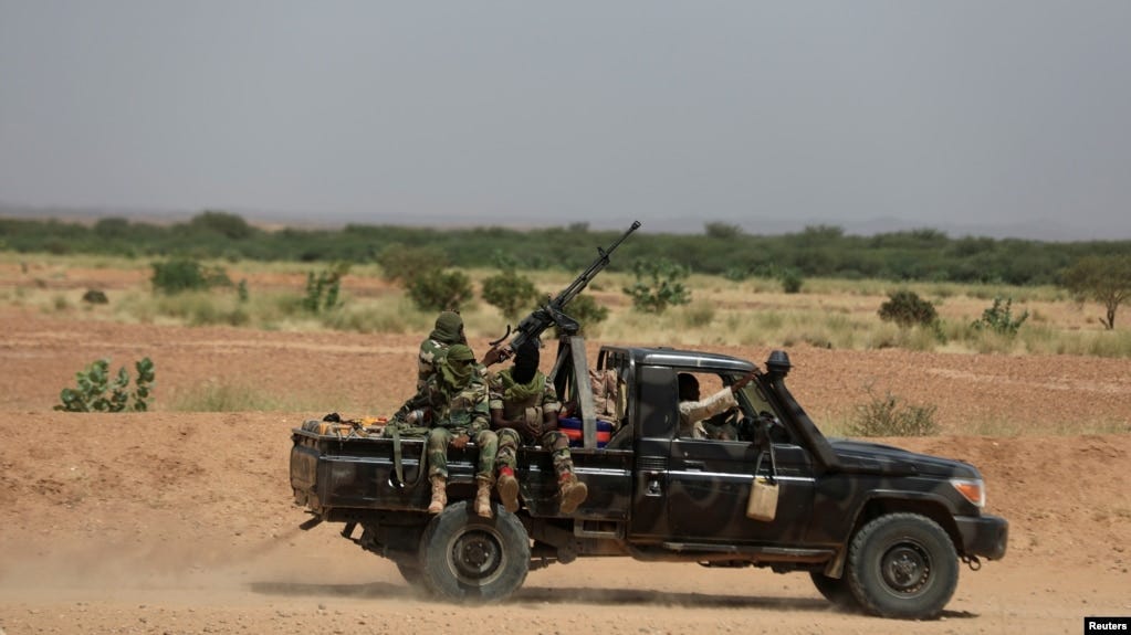 FILE - Niger's army soldiers ride on a pickup truck near Agadez, Niger, Oct. 29, 2019.