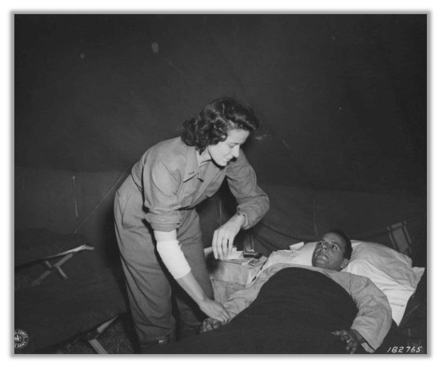 Photograph of Cordelia Cook Fillmore caring for a wounded soldier.  Her forearm is injured and wrapped in bandages.