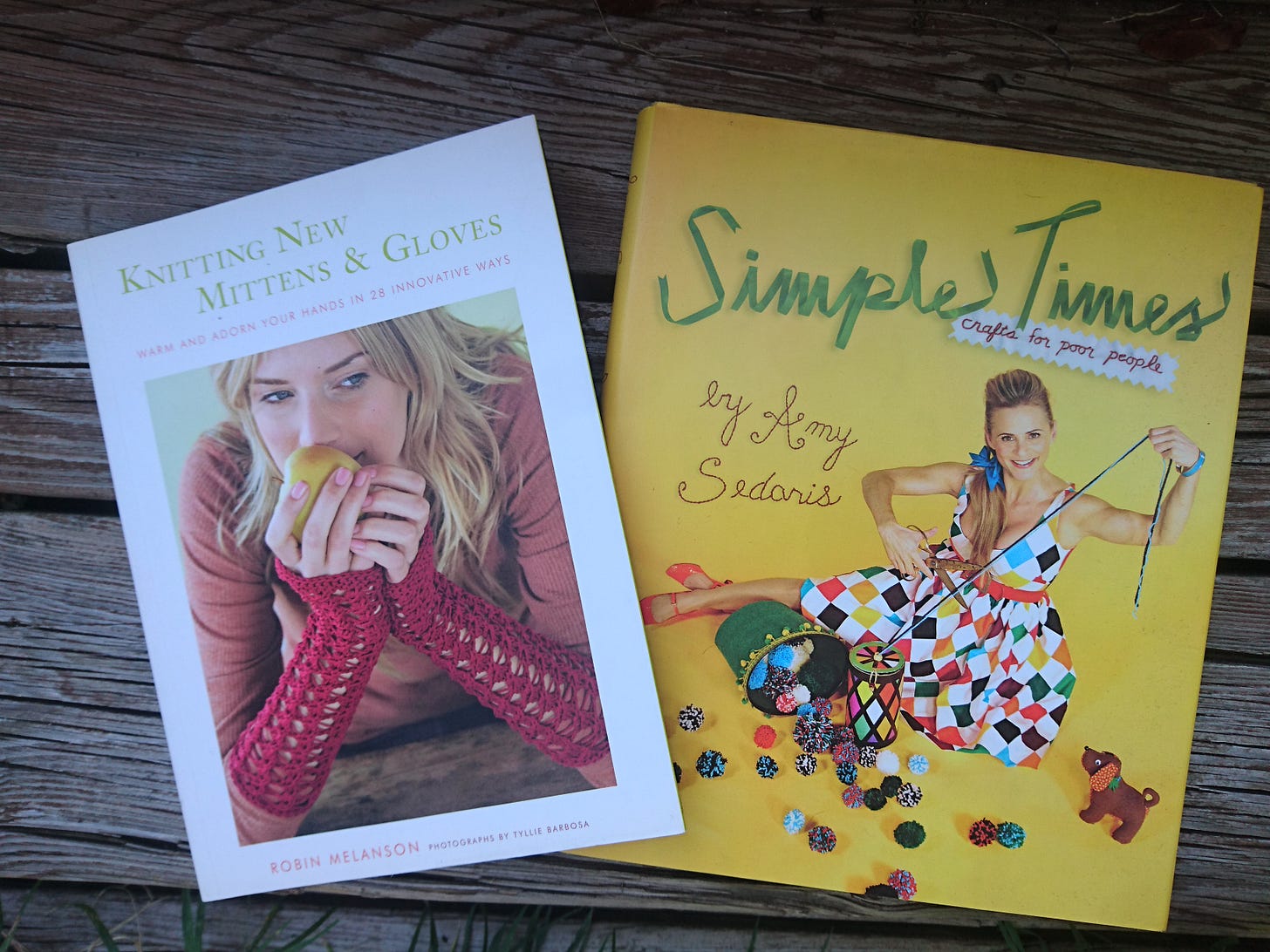 A top down view of the last two books mentioned on a grey wooden stair