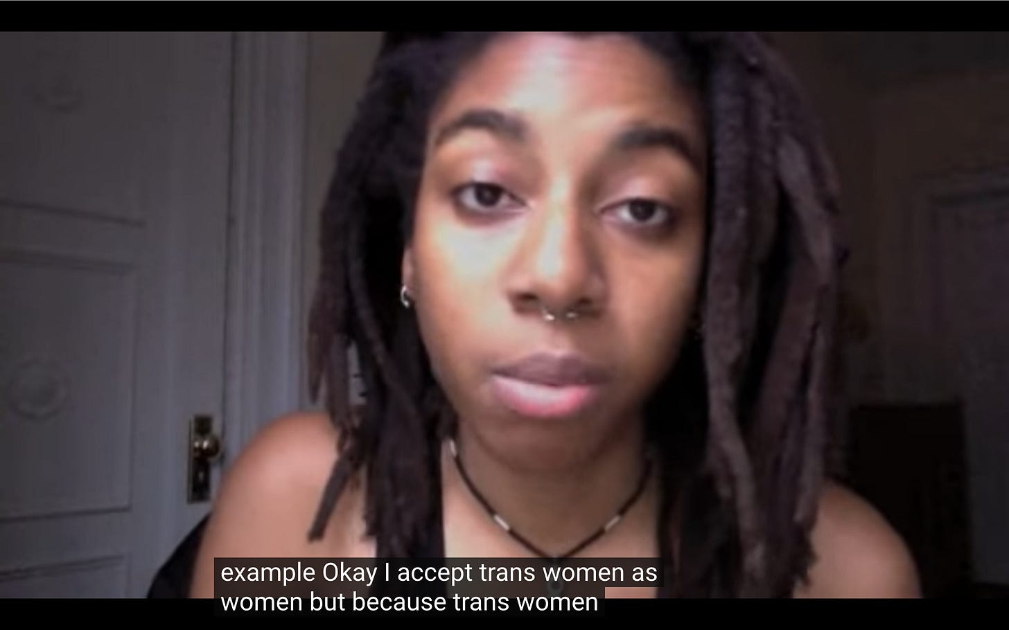 image of n3vlynnn speaking in front of the camera. The subtitle caption says, "I accept trans women as women"