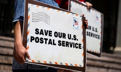 People hold signs reading ‘Save our US Postal Service’ in Pasadena, California, in August 2020. 