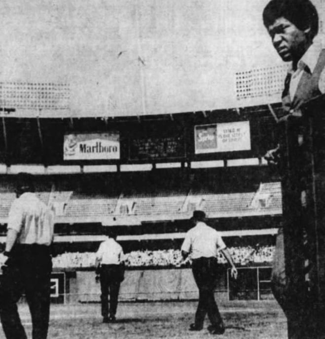 The umpires return to work under the replay scoreboard.