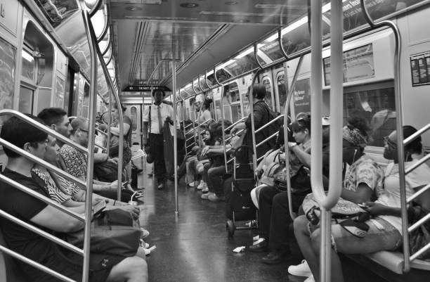 People Riding Inside of Subway Car