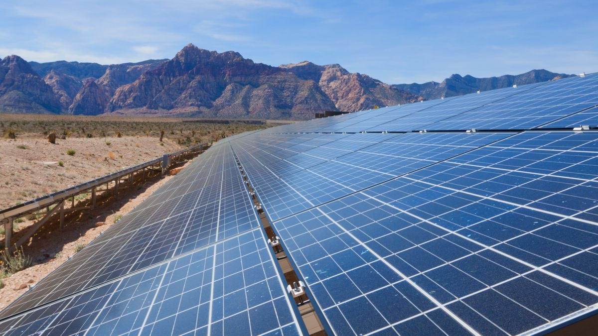 Tilted solar panels near the mountains of the Mojave Desert.