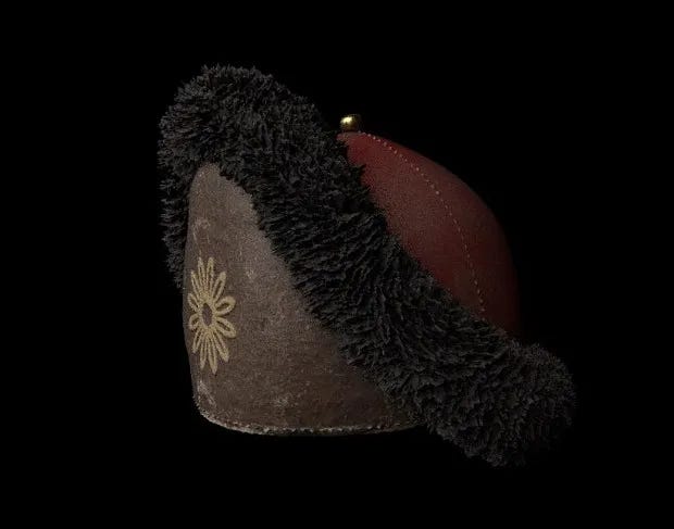 A round hat with a turned up brim, lined in fleece, against a dark background