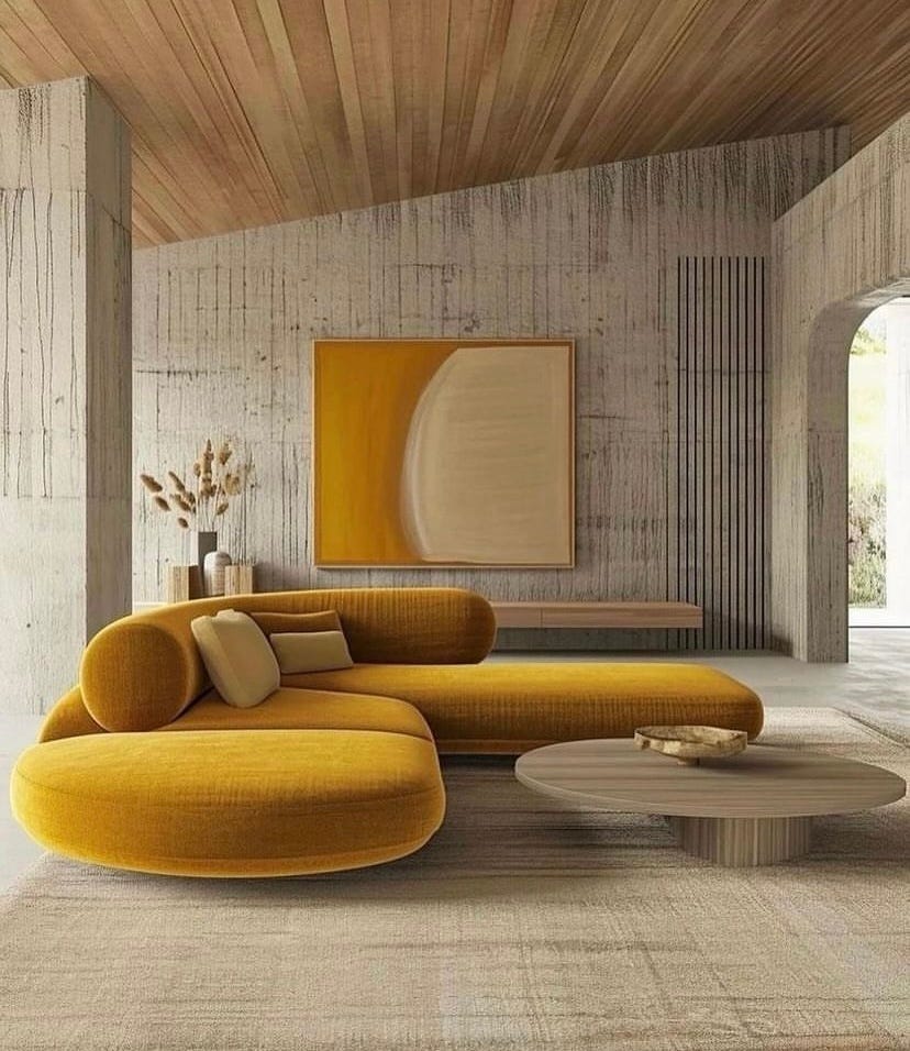 mustard coloured curved sofa in a neutral coloured room