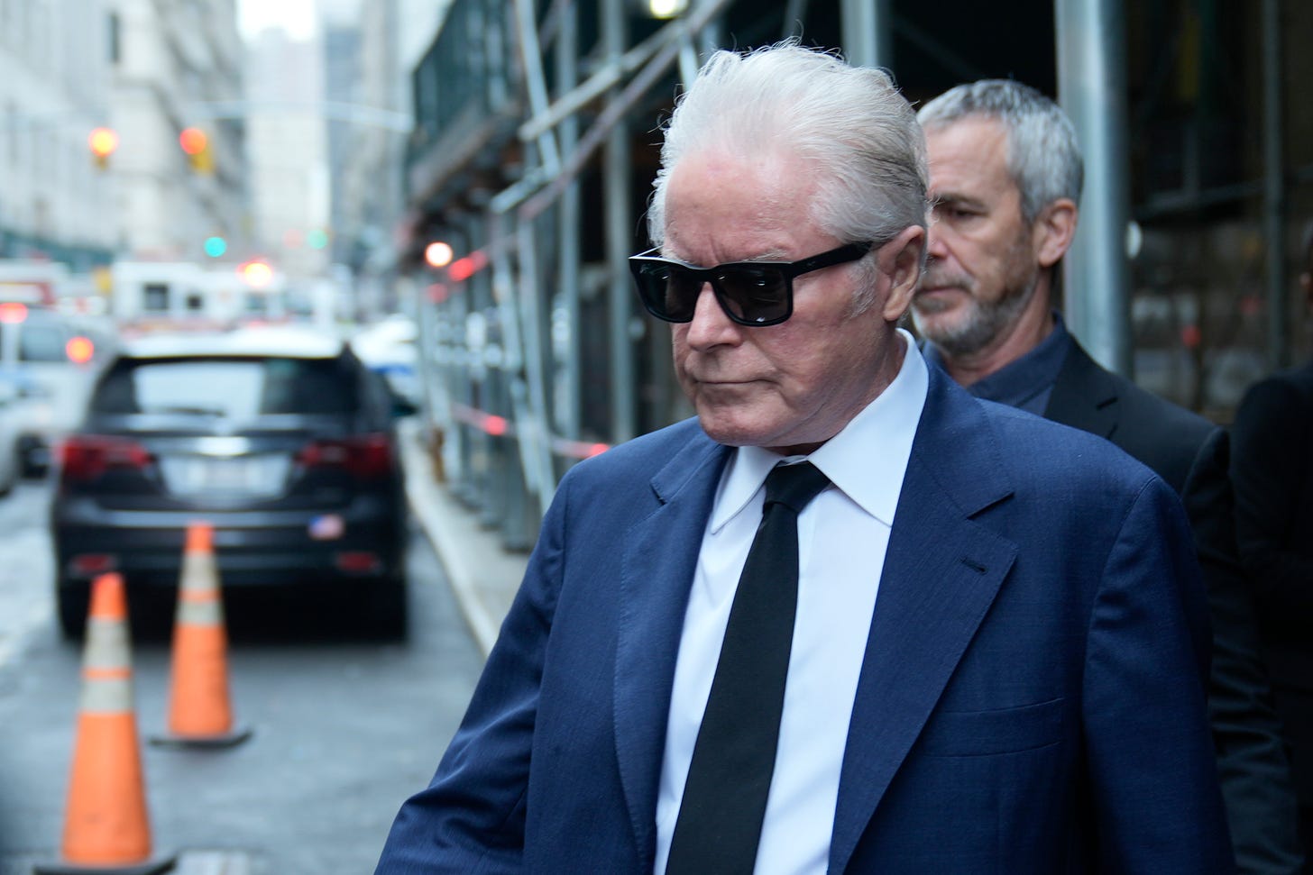 Musician Don Henley leaves the courthouse wearing sunglasses and a suit in New York.