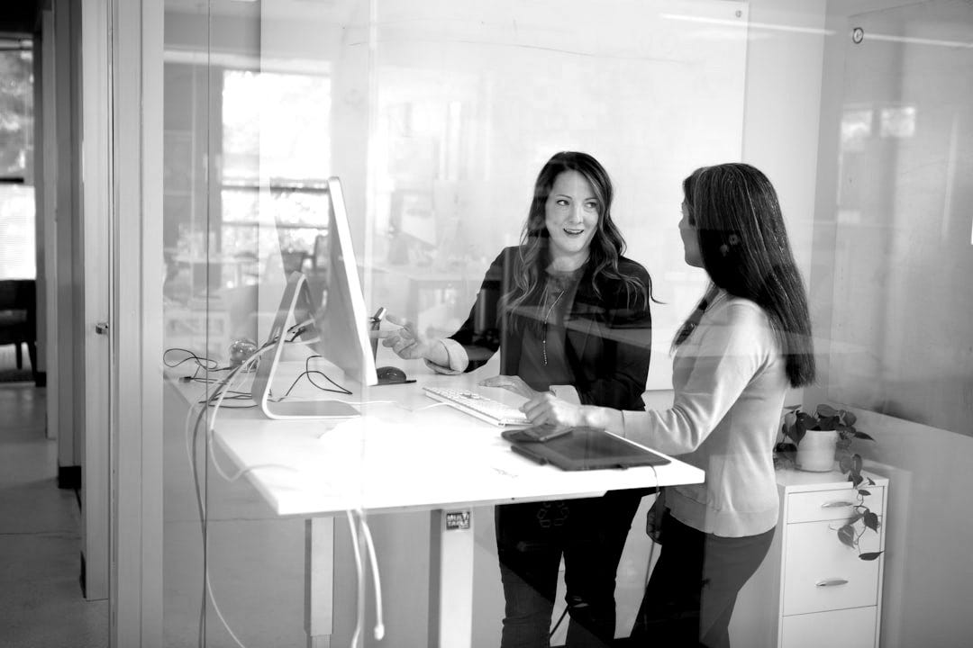 2 women sitting at table 2 women sitting at table