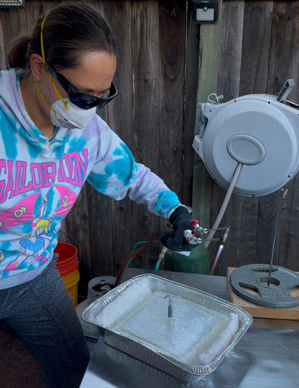 Liz tipping off a glass plasma piece