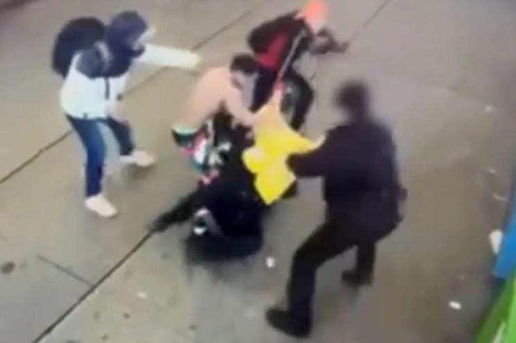 Surveillance footage of a group of migrants assaulting two NYPD officers in Times Square.