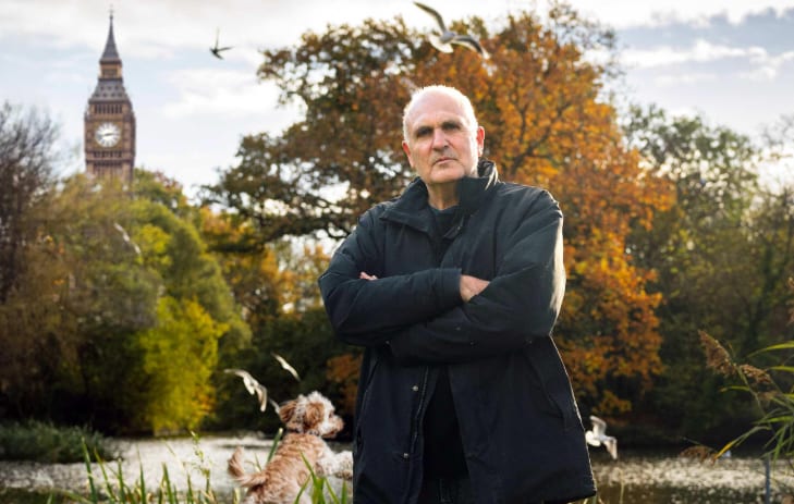 John Crace standing with his arms crossed, with Big Ben in the distance John Crace standing with his arms crossed, with Big Ben in the distance