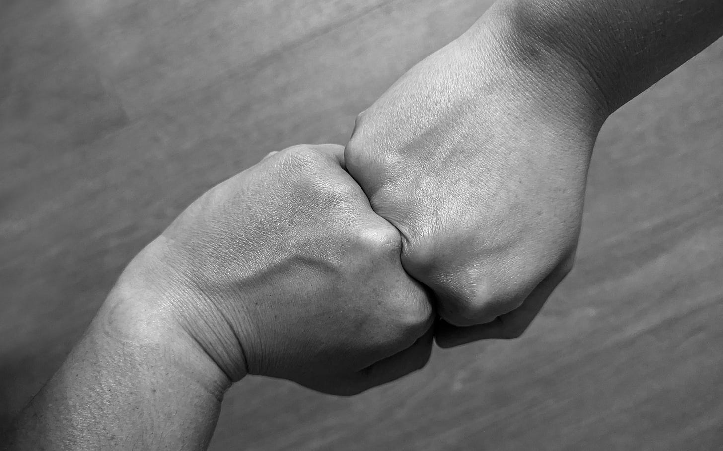Looking down at two fists in perfect opposition to each other.
