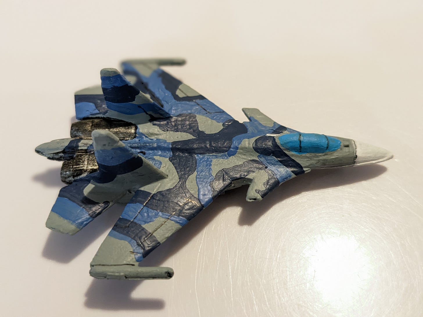 A 6 mm scale model of an SU-30/33 Russian fighter jet in blue, grey and dark blue camo