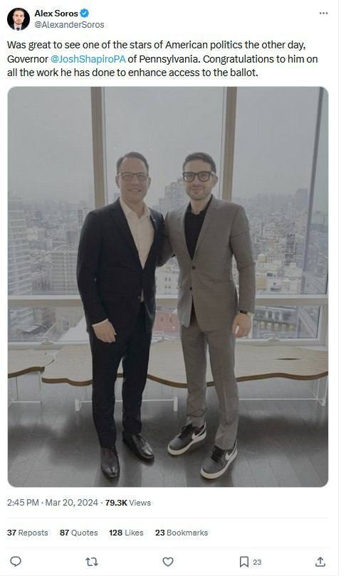 Two men standing in front of a window

Description automatically generated