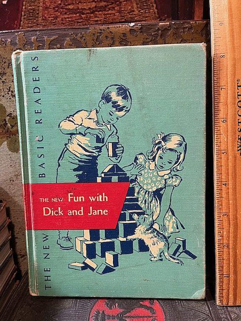 May include: A vintage children's book cover with a blue-green background. The cover features a boy and girl playing with blocks. The title of the book is 'The New Fun with Dick and Jane' and the words 'Basic Readers' are printed vertically on the left side of the cover.