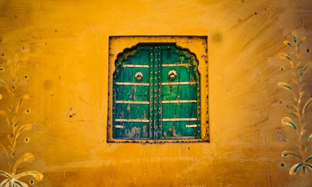 yellow wall, green window shutters