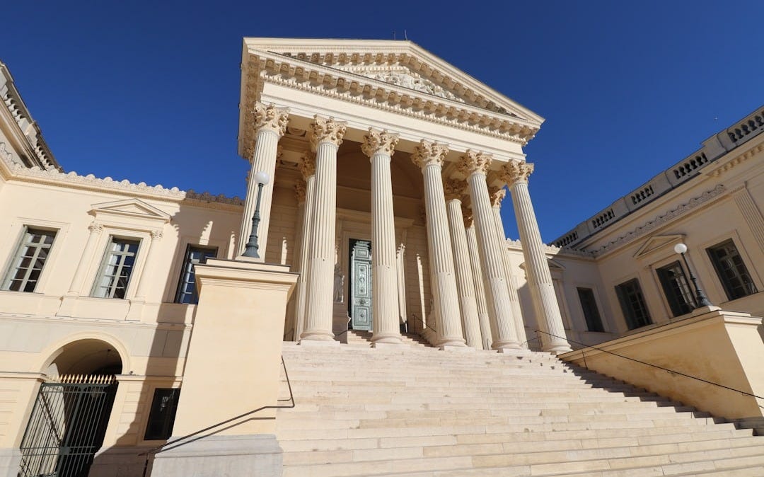 a large building with columns and a clock tower