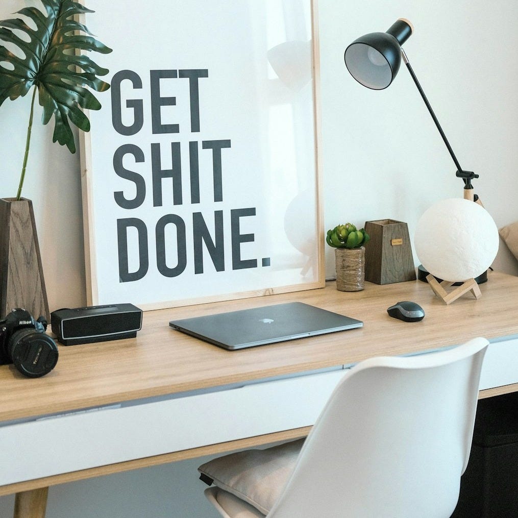 brown and white wooden desk with chair and laptop