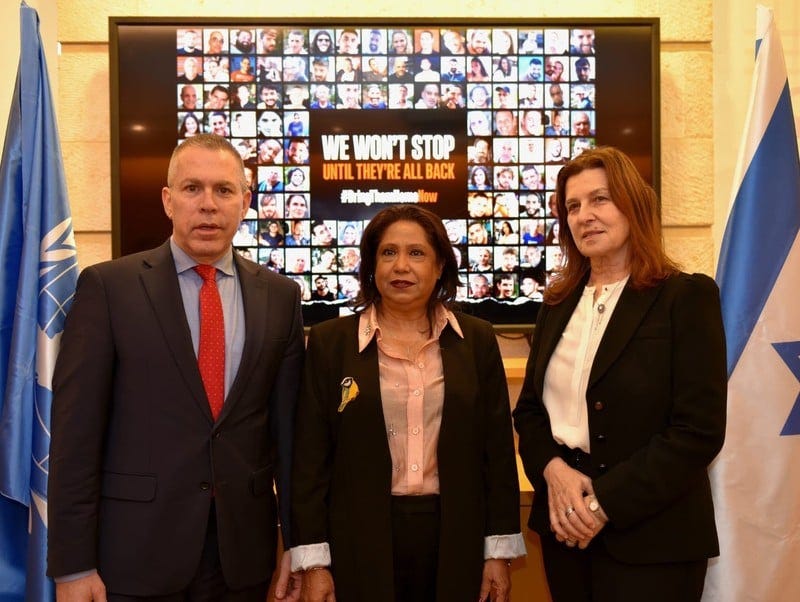 Three people pose in front of a photo collage