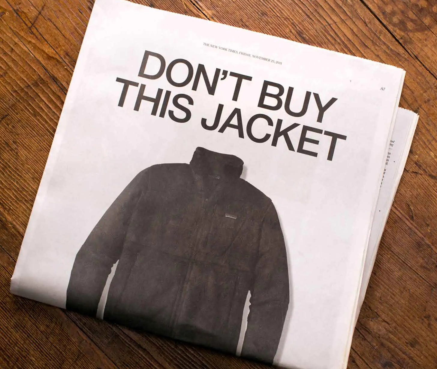 print edition of new york times with full page ad big letters saying don't buy this jacket