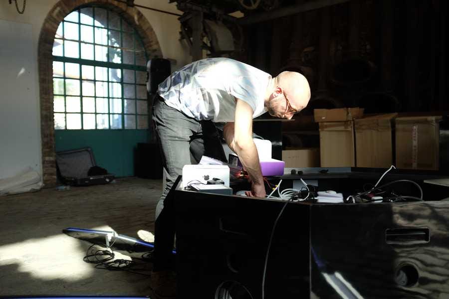 Photo showing Tim Murray-Browne building Cave of Sounds at Athens Science Festival. Photo by Anastasia Alekseeva. 