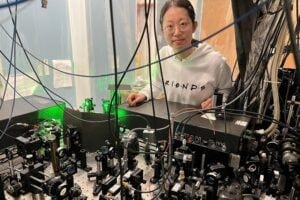 New experiments with ultra-cold atomic gases uncover universal physics in the dynamics of quantum systems. Penn State graduate student Yuan Le, the first author of the paper describing the experiments, stands near the apparatus she used to create and study one-dimensional gases near absolute zero. Credit: