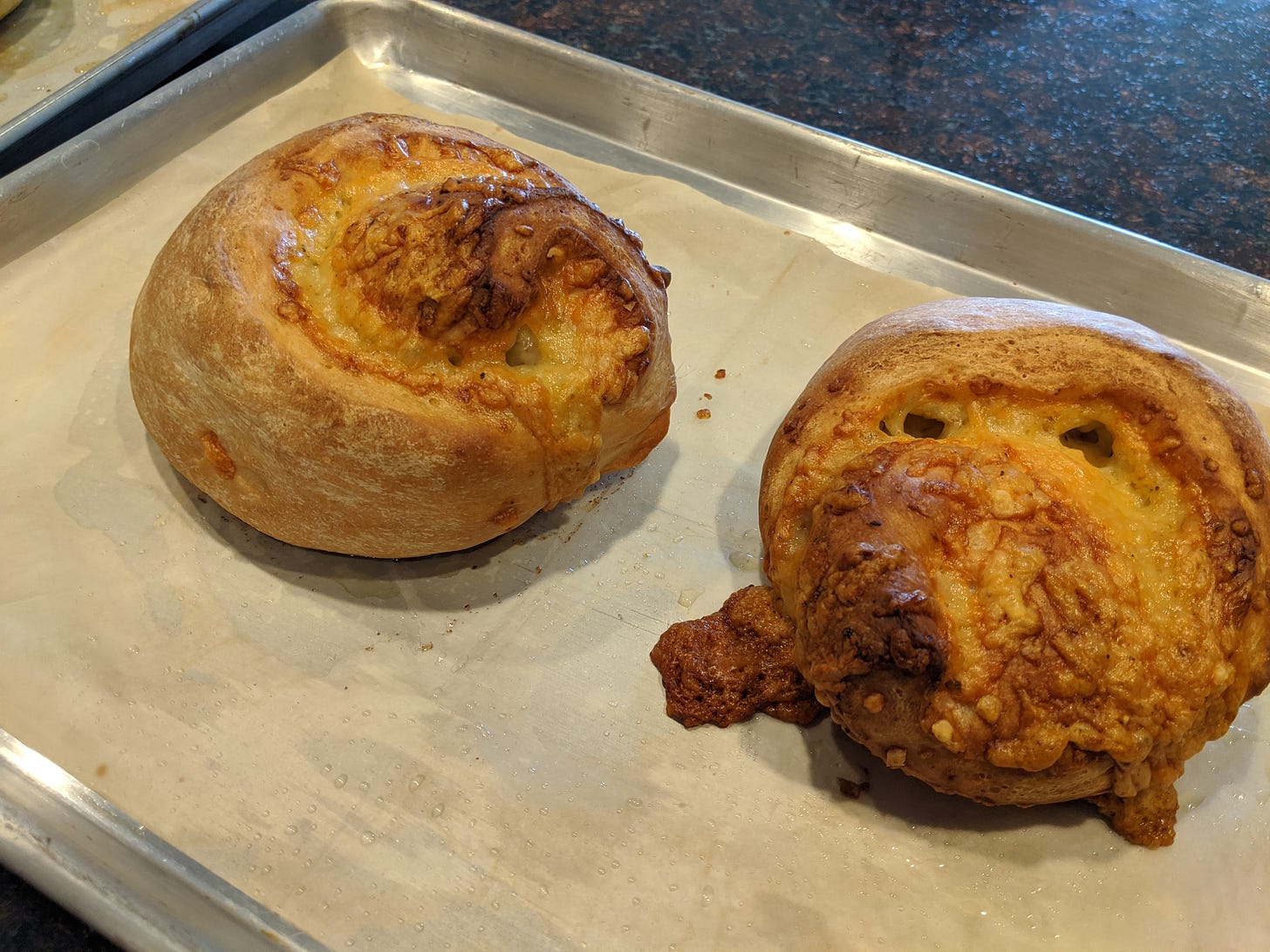 Photo of two round loaves of cheesy bread