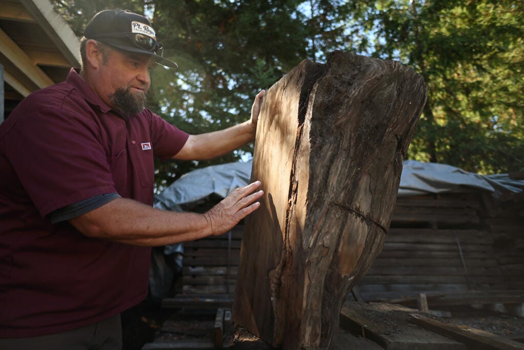 Jesse Almos of Sonoma Woodworks at his workshop in the Rincon Valley neighborhood of Santa Rosa. Photo taken Sept. 12, 2022. A rising talent, Almos, who crafted beautiful furniture from local fire-damaged trees and other salvaged wood, died suddenly on July 21. He was 49. (Erik Castro / for Sonoma Magazine file)